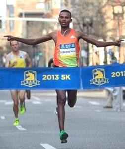 Dejen Gebremeskel, of Ethiopia, won the men's race in the Boston Athletic Association 5K on Sunday morning. (Photo: DINA RUDICK/GLOBE STAFF)